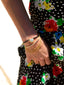 Close up model image of Venessa Arizaga FW26 Sweetheart Sparkle Bracelet (Black) - A layered bracelet with black threadwork, seed beads, gold plated chains, rhinestone chain, and a pave heart charm. 