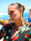 Model image of Venessa Arizaga FW26 Sweetheart Sparkle Necklace (Black) - A statement layered necklace with black threadwork, seed beads, gold plated chains, rhinestone chain, and a pave heart charm.
