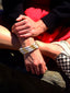 Close up model image of Venessa Arizaga FW26 Talk of The Town Bracelet -  A statement three-row gold beaded elastic bracelet with ceramic letter charms spelling "xo", "luv", "me", "you", "hi", "bye", "yes", "no", "omg"