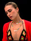 Venessa Arizaga SS26 Rainbow Aura Necklace layered at collarbone with the Rainbow Heartbeat Adjustable Necklace worn as a choker, rainbow charms catching the light, styled with Shimmer Huggie Hoops Pave earring with butterfly and mushroom, perfect for a sun-drenched Paradisiac escape and effortless beach vibe.