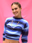 Resort-inspired adjustable multi-layer chain, thread and glass charms Color Crush Necklace worn long, and sparkling rhinestone stud and pave peace sign charm dangling earrings, styled with SS26 resort wardrobe on a model for a sunny surf-inspired look by Venessa Arizaga.