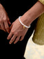 Close up of Venessa Arizaga SS26 Happy Mood Bracelet - made with elastic, white jade, and brass key charm - radiating handmade positivity