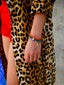 Model’s wrist wearing the Happy Mood Bear bracelet with vibrant purple jade beads and sweet gold teddy bear charm, Butterfly bracelet with orange jade beads and butterfly charm, and Horseshoe bracelet with green jade beads and horseshoe charm