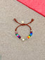 Lifestyle image of Venessa Arizaga FW26 Love Spark Bracelet - adjustable beaded bracelet with rust threadwork, pave accents, and letter beads spelling LOVE with a heart charm.