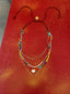 Lifestyle image of Venessa Arizaga FW26 Sweetheart Sparkle Necklace (Rainbow) - A statement layered necklace with rust threadwork, rainbow seed beads, gold plated chains, rhinestone chain, and a pave heart charm. Necklace with colorful beads on a red background