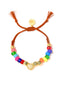 Venessa Arizaga FW26 Love Spark Bracelet - adjustable beaded bracelet with rust threadwork, pave accents, and letter beads spelling LOVE with a heart charm.