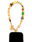 Venessa Arizaga FW26 Glitter Galaxy Phone Leash - A golden beaded phone strap/bag charm with ceramic and wooden charms in star, clover, bear, ladybug, butterfly, and flowers, perfect for making an everyday statement