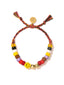 Venessa Arizaga Happy AF Bracelet (Rainbow Sunset) - An adjustable friendship bracelet with dark rainbow threadwork, glass beads, ceramic smiley charm, and pave rhinestone letters that say AF.