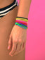 Woman’s wrist featuring the Bright Side Butterfly bracelet with purple thread and gold butterfly charm