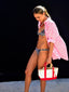 Venessa Arizaga SS26 Sugar Rush Love Necklace in adjustable leather cord with glass and ceramic charms, Sugar Rush Love Bag/Key Charm attached to tote, and Love You Mucho Elastic Bracelet in Red with jade and ceramic charms, styled with Shimmer Huggie Hoop Earrings with Pave heart charms, love heart motif bringing together a playful look. Perfect for valentine's day and every day.