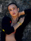Model image of Venessa Arizaga FW26 Dreamwave Necklace - Two rows of gold beads and playful charms including a smiley face, ladybug, mushroom, alien, and star, and the Dreamwave Bracelet - Five rows of elastic gold beads and charms including a smiley face, ladybug, mushroom, alien, and star.