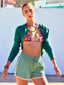 Model image of Venessa Arizaga FW26 Rainbow Reaction Necklace and Bracelet - A colorful beaded necklace and bracelet  with rainbow jade gradient beads and glass and ceramic charms including lipstick, ladybug, smiley, daisy, mushroom, cactus, eyeball, and alien, and Don't Worry Be Happy Bracelet (Candy Rainbow) -  A colorful beaded elastic bracelet in dyed jade and ceramic, radiating handmade positivity. Perfect for every day layering