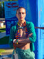 Model image of Venessa Arizaga FW26 Over The Rainbow Necklace & Bracelet - A colorful beaded statement necklace and bracelet with rainbow gradient charms including heart, flower, smiley, clover, eyeball, mushroom, butterfly, bead, and ladybug in ceramic, wood, and glass, and Over The Rainbow Phone Leash, a statement multi use phone accessory and bag charm with iconic charms in rainbow hues.