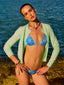 Model image of Venessa Arizaga FW26 Venus Heart Necklace (Rainbow) - A statement necklace with rainbow beads, pave accents, and a gold heart pendant, Venessa Arizaga FW26 Venus Heart Bracelet (Rainbow) - An everyday adjustable bracelet with rust threadwork, colorful beads, pave accents, and a gold heart pendant, and Love Spark Bracelet - adjustable beaded bracelet with rust threadwork, pave accents, and letter beads spelling LOVE with a heart charm