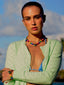 Model image of Venessa Arizaga FW26 Venus Heart Necklace (Rainbow) - A statement necklace with rainbow beads, pave accents, and a gold heart pendant, Venessa Arizaga FW26 Venus Heart Bracelet (Rainbow) - An everyday adjustable bracelet with rust threadwork, colorful beads, pave accents, and a gold heart pendant, perfect for everyday wear.