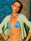 Model image of Venessa Arizaga FW26 Venus Heart Necklace (Rainbow) - A statement necklace with rainbow beads, pave accents, and a gold heart pendant, Venessa Arizaga FW26 Venus Heart Bracelet (Rainbow) - An everyday adjustable bracelet with rust threadwork, colorful beads, pave accents, and a gold heart pendant, and Love Spark Bracelet - adjustable beaded bracelet with rust threadwork, pave accents, and letter beads spelling LOVE with a heart charm