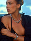 Model image of Venessa Arizaga FW26 Big Heart Necklace (Silver) - A silver beaded statement necklace with a large heart pendant, and FW26 Big Heart Bracelet (Silver) -  A silver beaded elastic statement bracelet with a large heart pendant.