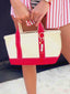 Close up of Venessa Arizaga SS26 Sugar Rush Love Bag/Key Charm attached to tote, love heart motif bringing together a playful look. Perfect for valentine's day and every day.