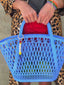 Close up video of Venessa Arizaga SS26 Sugar Rush Happy Bag/Key Charm attached to tote, smiley motif bringing whimsical joy. Styled with Happy Mood Bracelets in elastic with purple, green, and orange jade beads and bear, horseshoe, and butterfly icons. 
