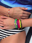 Close up video of model wearing Venessa Arizaga SS26 multi-layer chain and crystal pearl + glass beads Color Crush bracelet, and a rainbow stack of Bright Side Cord and charm friendship bracelets for a playful, elevated everyday bracelet stack.
